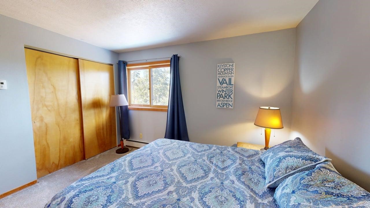 91200 Ryan Gulch Road, Unit 213 Silverthorne, CO 80498 - Photo 16 of 33 a bedroom with a bed and a window