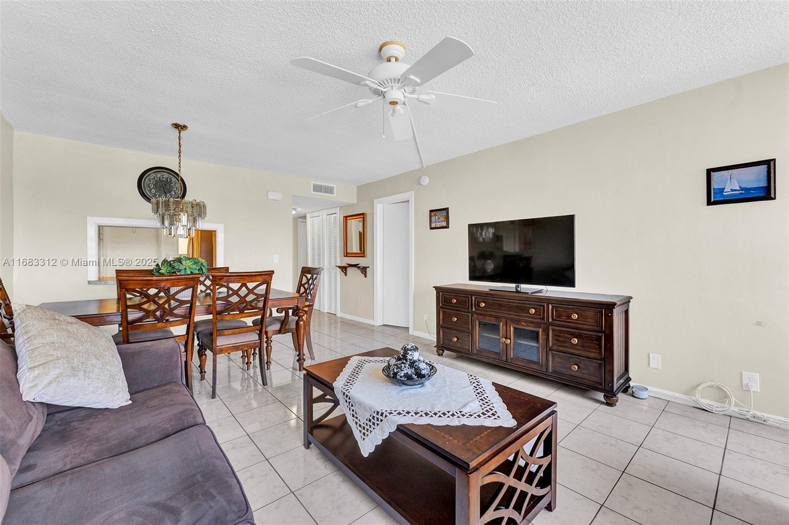 330 Southeast 2nd Street, Unit 303F Hallandale Beach, FL 33009 - Photo 12 of 26 a living room with furniture and a flat screen tv