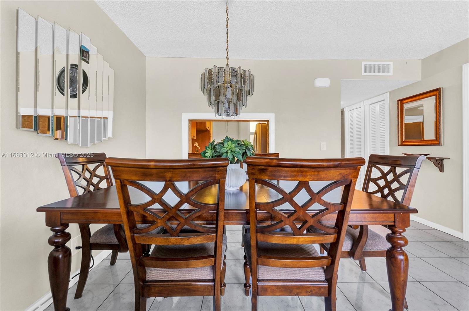 330 Southeast 2nd Street, Unit 303F Hallandale Beach, FL 33009 - Photo 9 of 26 a view of a dining room with furniture and chandelier