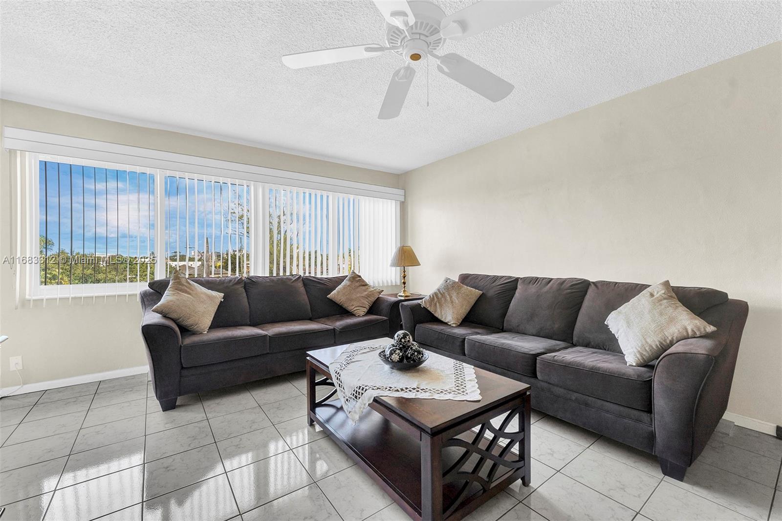 330 Southeast 2nd Street, Unit 303F Hallandale Beach, FL 33009 - Photo 10 of 26 a living room with furniture and a large window
