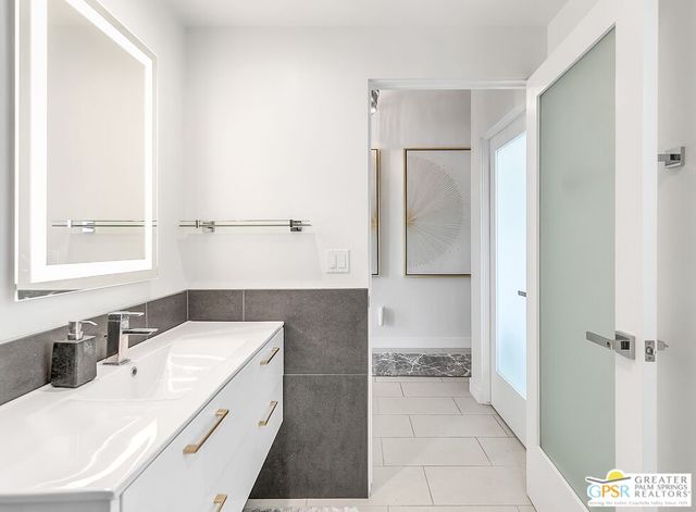 a bathroom with a sink and a mirror