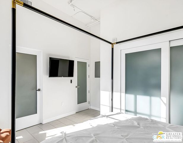 a view of a hallway with wooden floor and cabinet
