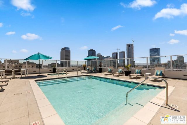 a view of a swimming pool and lounge chairs
