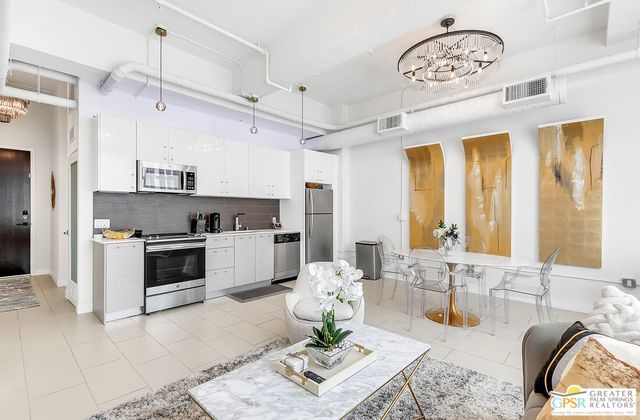 a open kitchen with stainless steel appliances granite countertop a stove a sink and a refrigerator