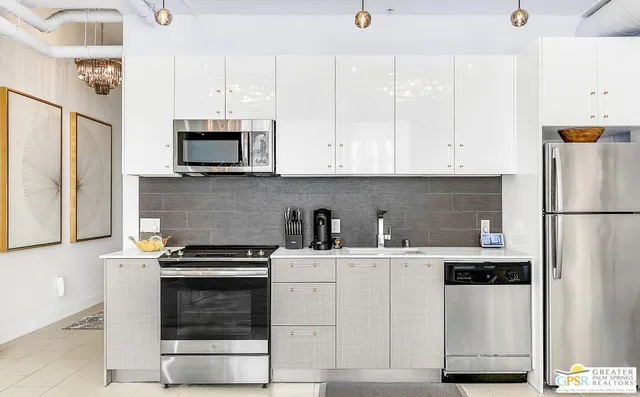 a kitchen with stainless steel appliances a stove a microwave and a refrigerator