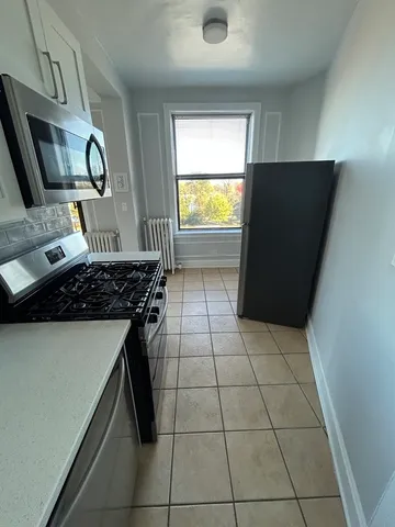 a kitchen with a sink a stove and a refrigerator