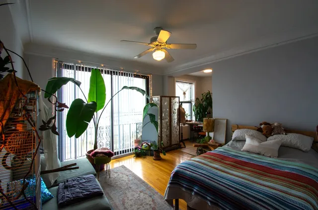 a bedroom with two beds and a chandelier