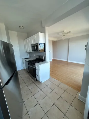 a kitchen with stainless steel appliances a stove a sink and a refrigerator