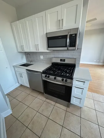 a kitchen with cabinets a sink and appliances