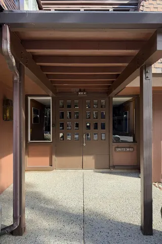 a kitchen with stainless steel appliances kitchen island granite countertop a refrigerator and a sink