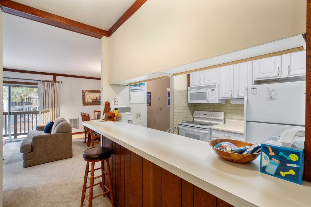 440 Shirley Cyn Road, Unit 50 Olympic Valley, CA 96146 - Photo 25 of 28 a kitchen with stainless steel appliances kitchen island granite countertop a refrigerator and a sink