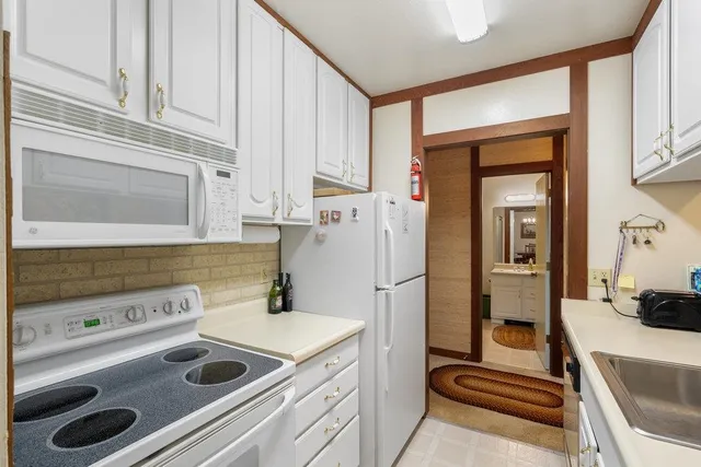 a kitchen with a stove and a refrigerator