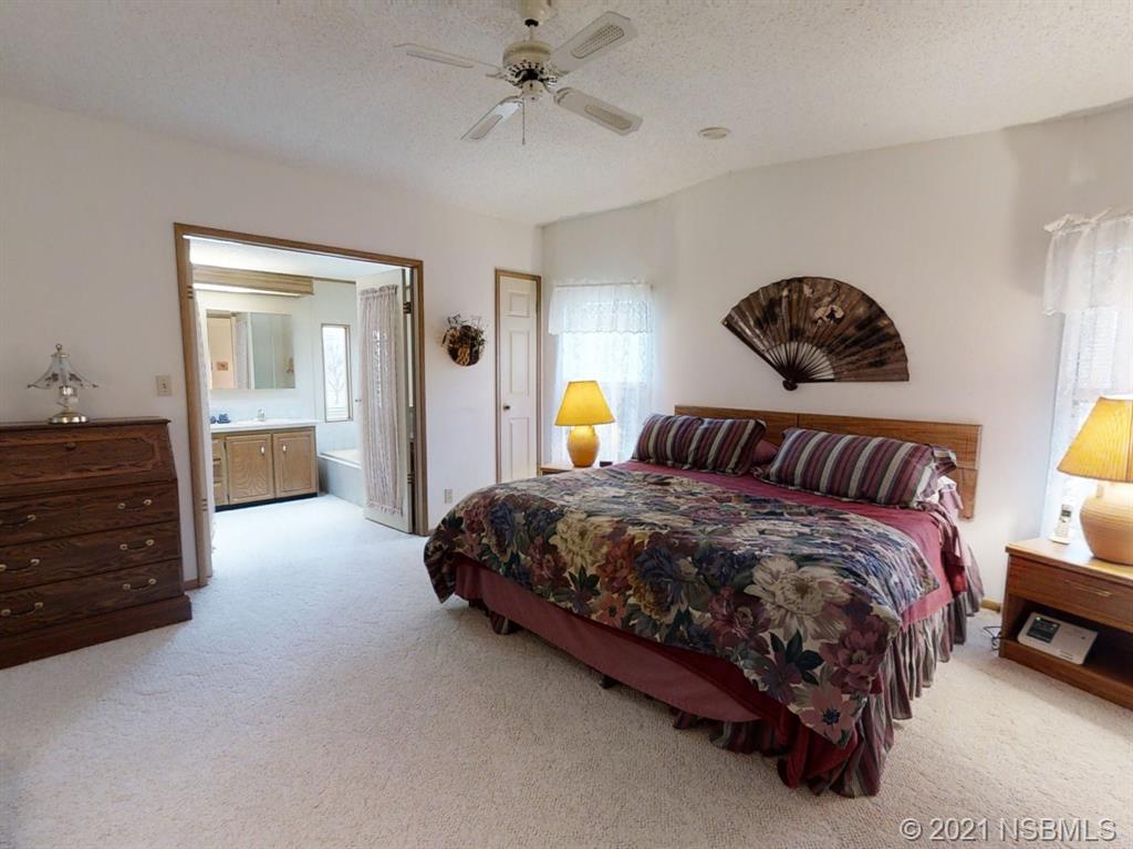 705 Navigators Way Edgewater, FL 32141 - Photo 5 of 33 a bedroom with a bed and a cabinets