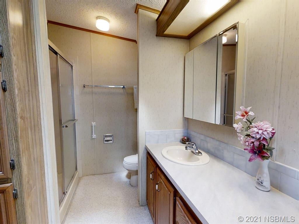 705 Navigators Way Edgewater, FL 32141 - Photo 8 of 33 a bathroom with a sink a vanity and a mirror