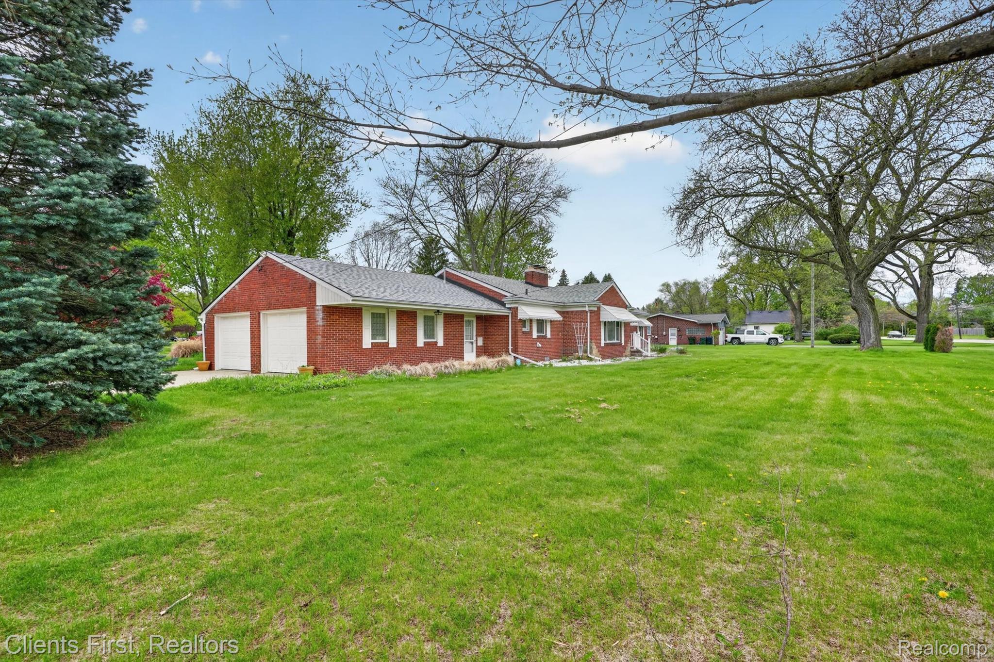 11000 Clinton River Road Sterling Heights, MI 48314 - Photo 2 of 33 Ranch-style home with a chimney, a front yard, and brick siding