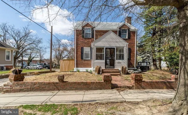 a front view of a house with cars parked