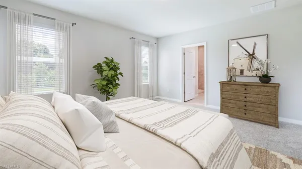 a bedroom with a bed and dresser