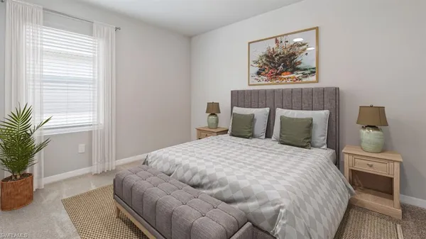 a bedroom with a large bed and a potted plant