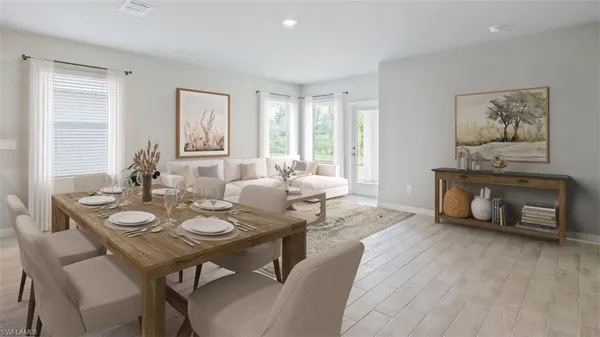 a dining room with furniture window and wooden floor