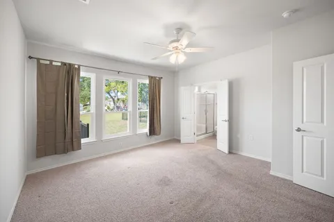 an empty room with windows and entrance