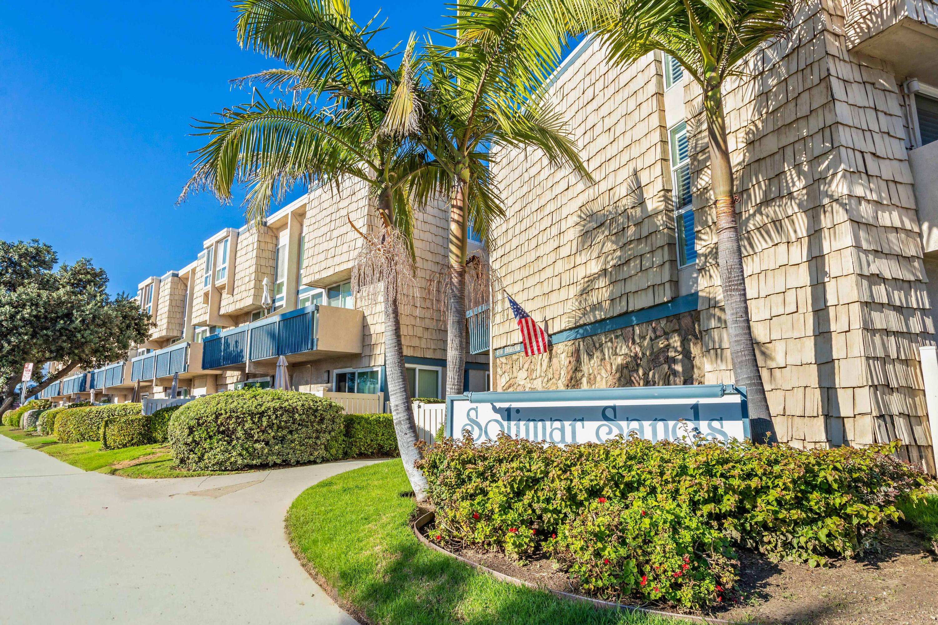 a view of a house with a fountain and a garden