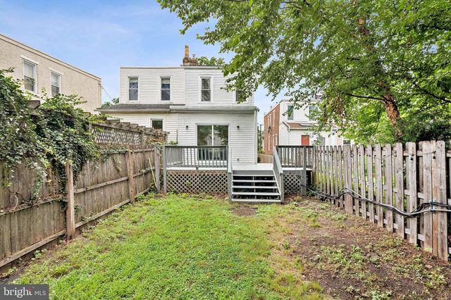 a balcony with a yard and wooden fence