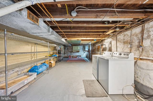 a view of storage and utility room with washer and dryer