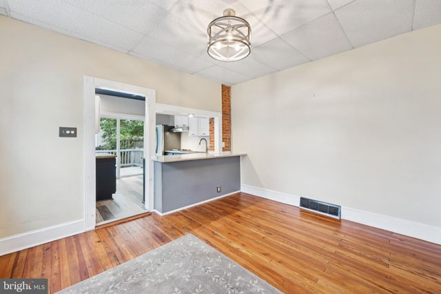 a view of a room with wooden floor and window