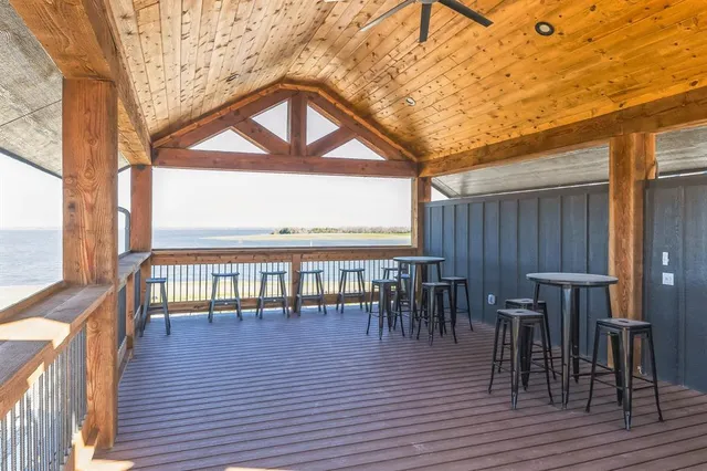 a view of a patio with couches table and chairs and wooden floor