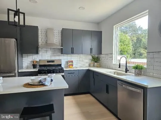 a kitchen with a sink a stove a refrigerator a center island and cabinets