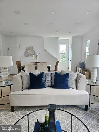 a living room with furniture and a painting on the wall