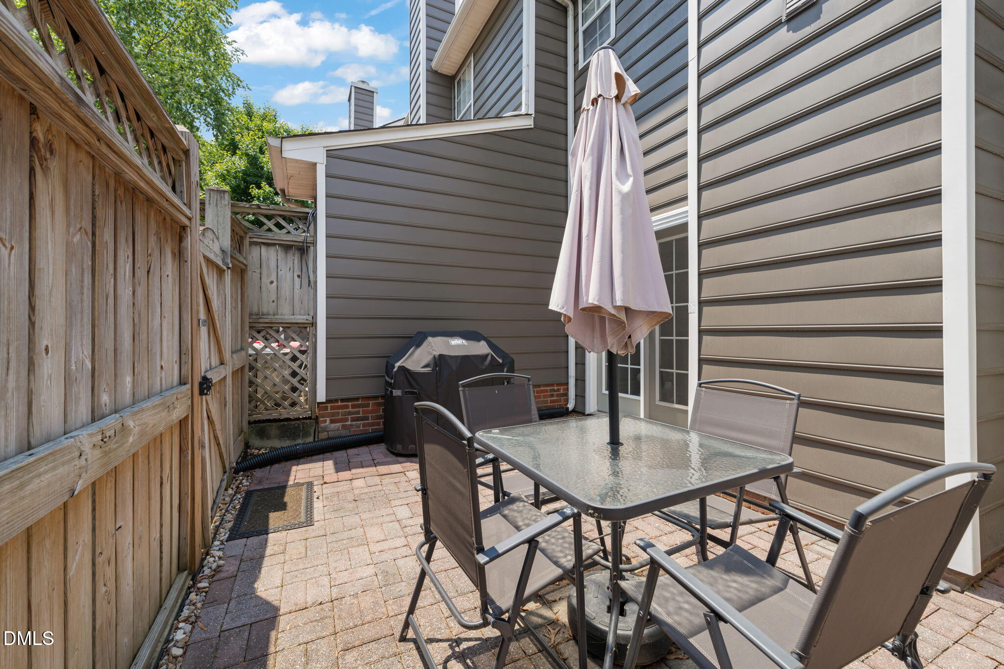 4323 Pine Springs Court Raleigh, NC 27613 - Photo 34 of 38 a backyard of a house with table and chairs