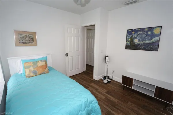 a bedroom with a bed and a desk