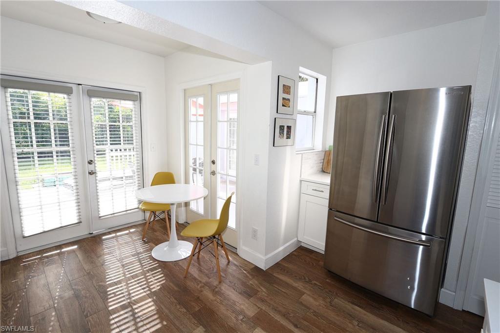714 11th Street North Naples, FL 34102 - Photo 15 of 27 a kitchen with a refrigerator and wooden floor