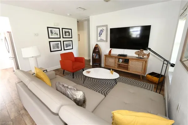 a living room with furniture and a flat screen tv