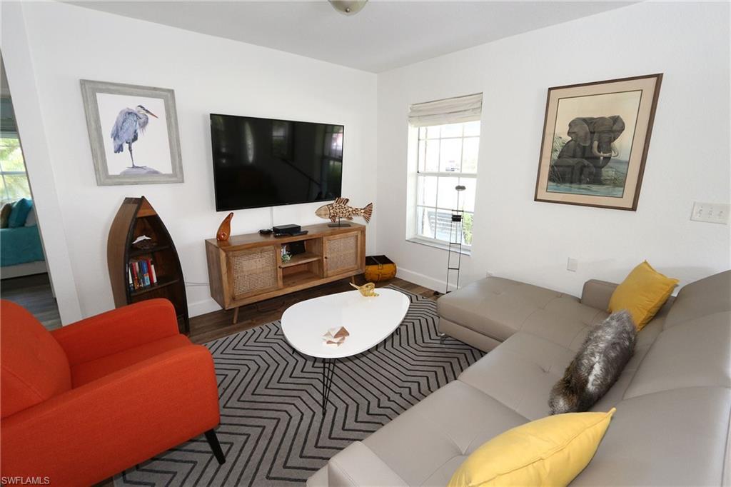 714 11th Street North Naples, FL 34102 - Photo 17 of 27 a living room with furniture and a flat screen tv