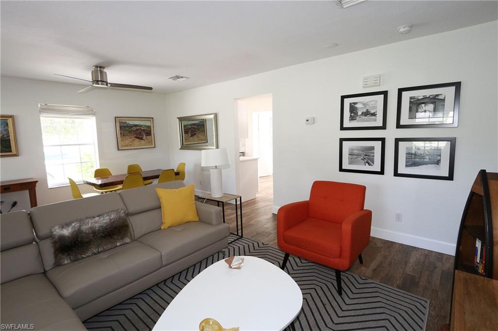 714 11th Street North Naples, FL 34102 - Photo 19 of 27 a living room with furniture and a flat screen tv