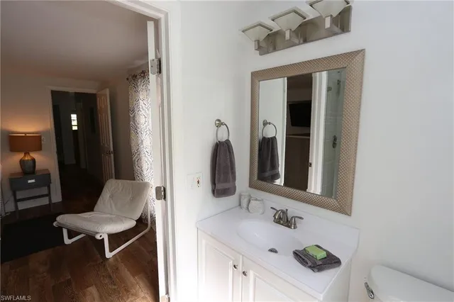 a bathroom with a sink vanity and a mirror