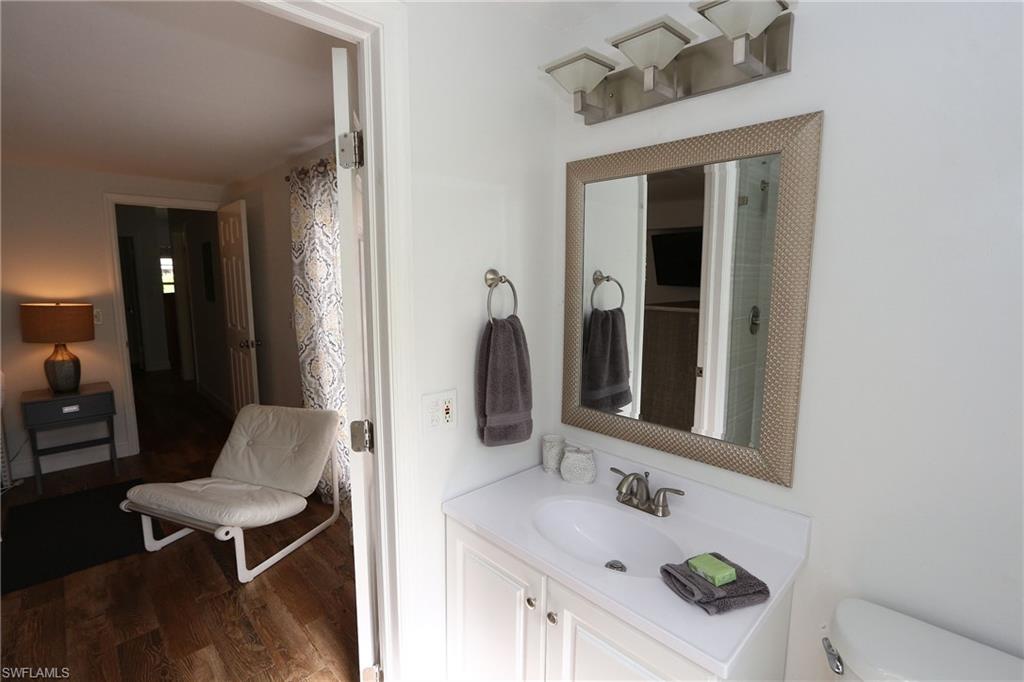 714 11th Street North Naples, FL 34102 - Photo 20 of 27 a bathroom with a sink vanity and a mirror