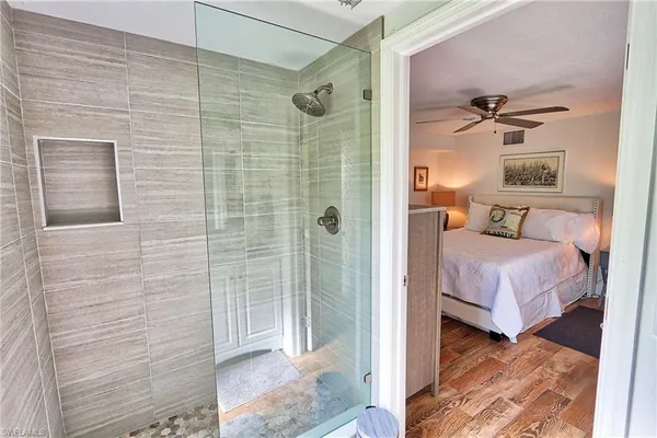 a bedroom with a bed and a shower