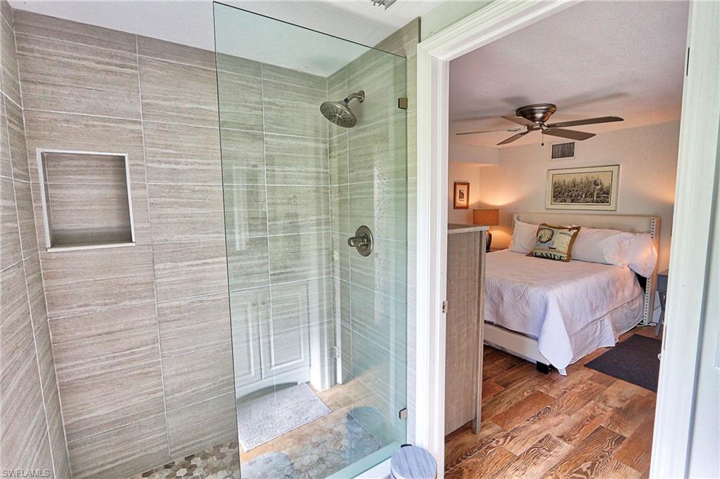 714 11th Street North Naples, FL 34102 - Photo 21 of 27 a bedroom with a bed and a shower