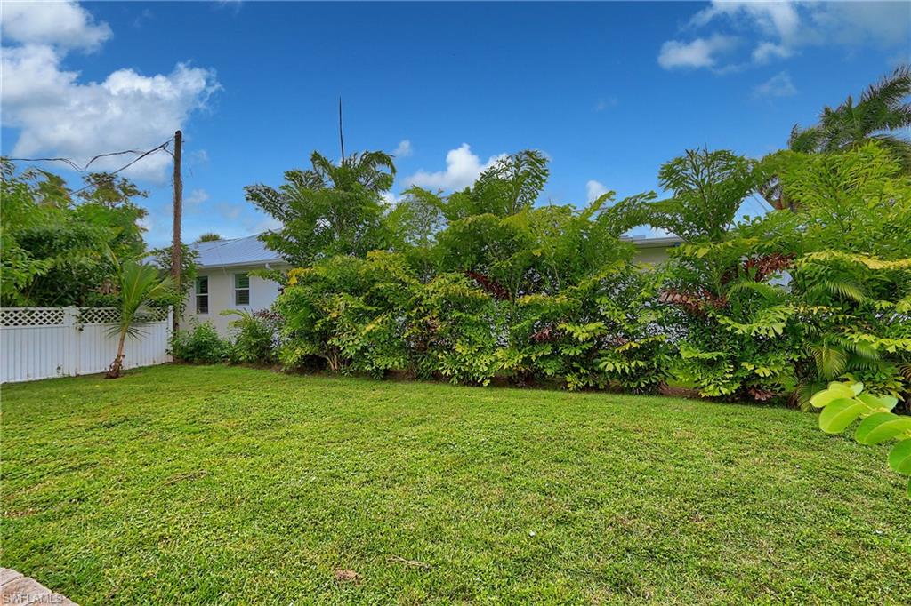714 11th Street North Naples, FL 34102 - Photo 27 of 27 a backyard of a house with lots of green space