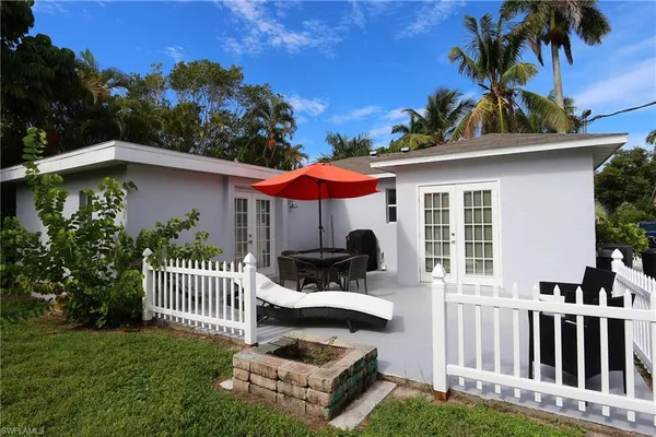 a view of a house with a yard porch and furniture