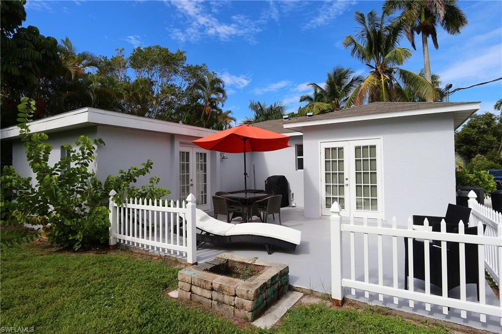 714 11th Street North Naples, FL 34102 - Photo 6 of 27 a view of a house with a yard porch and furniture