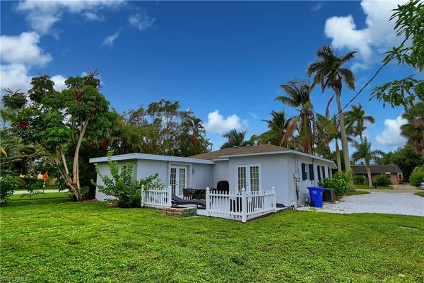 a view of a house with a yard and sitting area
