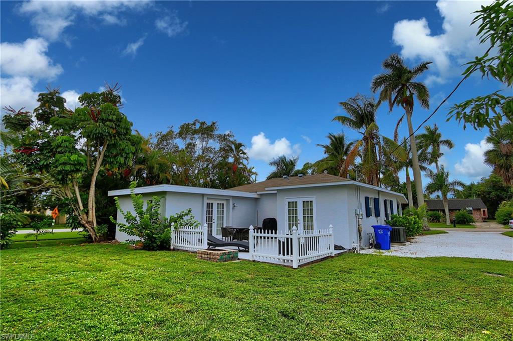 714 11th Street North Naples, FL 34102 - Photo 7 of 27 a view of a house with a yard and sitting area