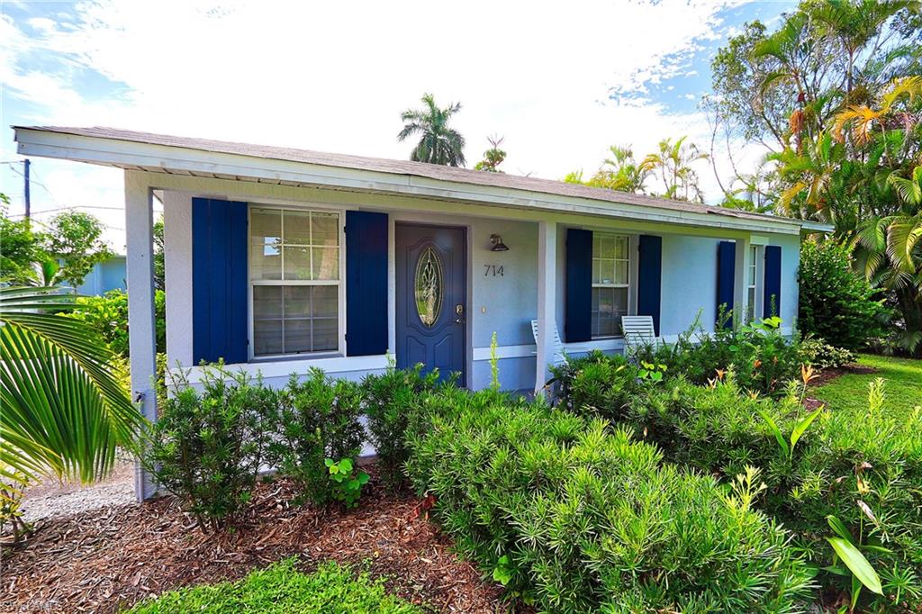 714 11th Street North Naples, FL 34102 - Photo 8 of 27 a view of a house with potted plants and a table