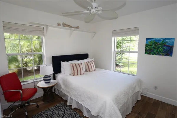 a large bed sitting in a bedroom next to a window