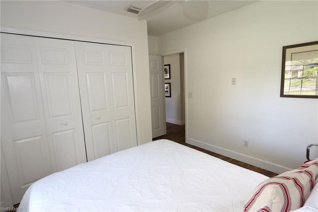 714 11th Street North Naples, FL 34102 - Photo 10 of 27 a bedroom with a bed and a window