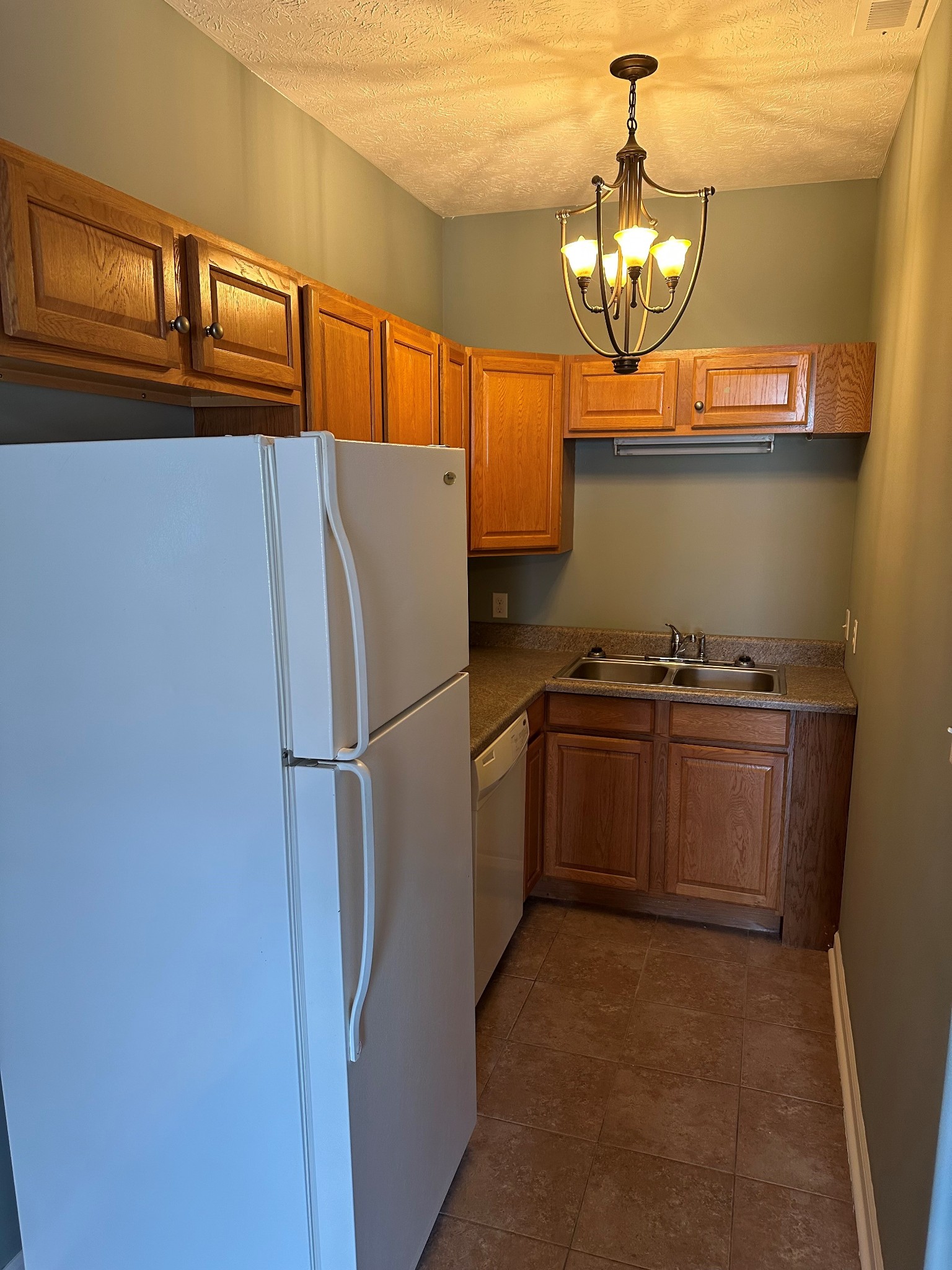 110 Case Road Prospect, TN 38477 - Photo 4 of 10 a kitchen with granite countertop a refrigerator and a stove top oven